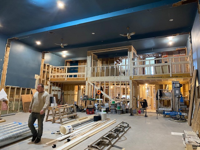 Interior of the theatre auditorium during renovations. The framing of the upstairs technical room and balcony are the focus.